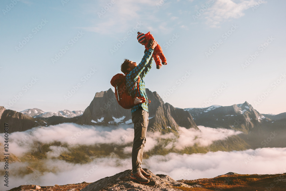 Father holding up baby in mountains happy family travel vacations with kids hike together active hea