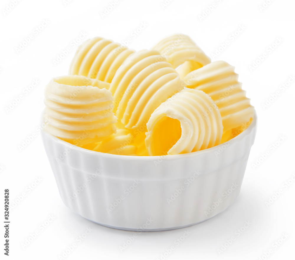 Butter curls or butter rolls in white bowl isolated on white background.