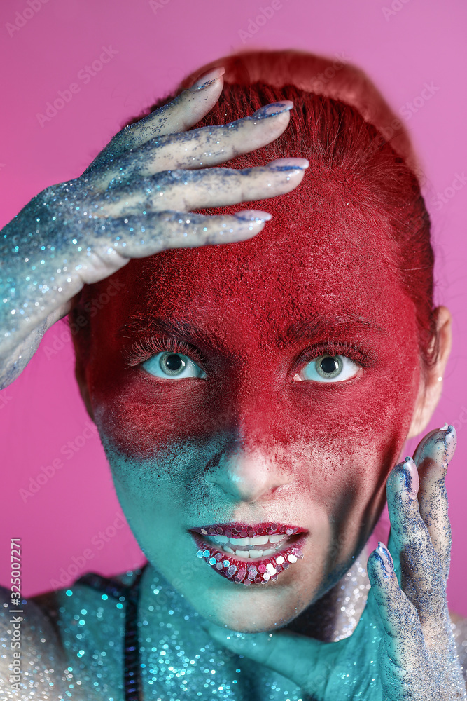 Beautiful woman with unusual makeup on color background