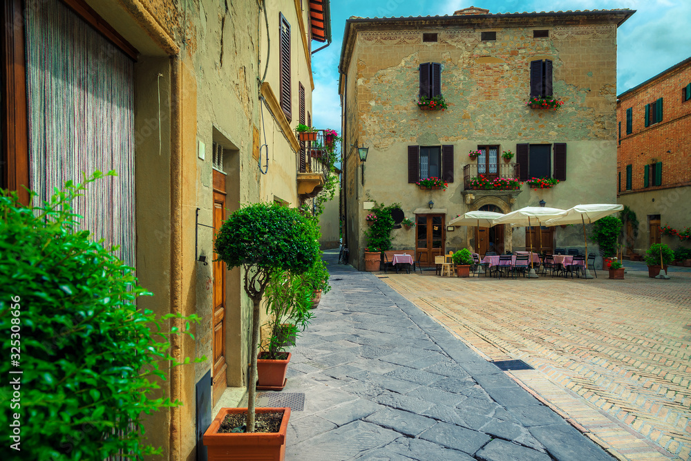 Cozy street cafe with outdoor furniture in Tuscany, Pienza, Italy