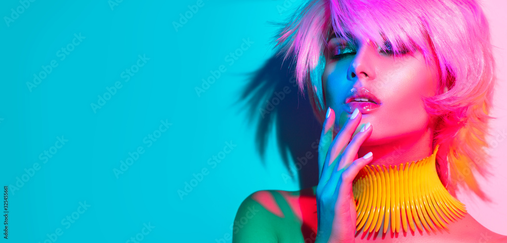 Fashion model woman in colorful bright lights, portrait of beautiful party girl with trendy make-up,