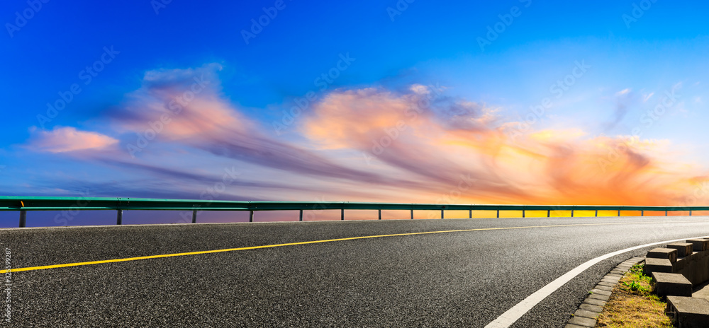 Empty asphalt road and beautiful colorful clouds landscape at sunset,panoramic view.