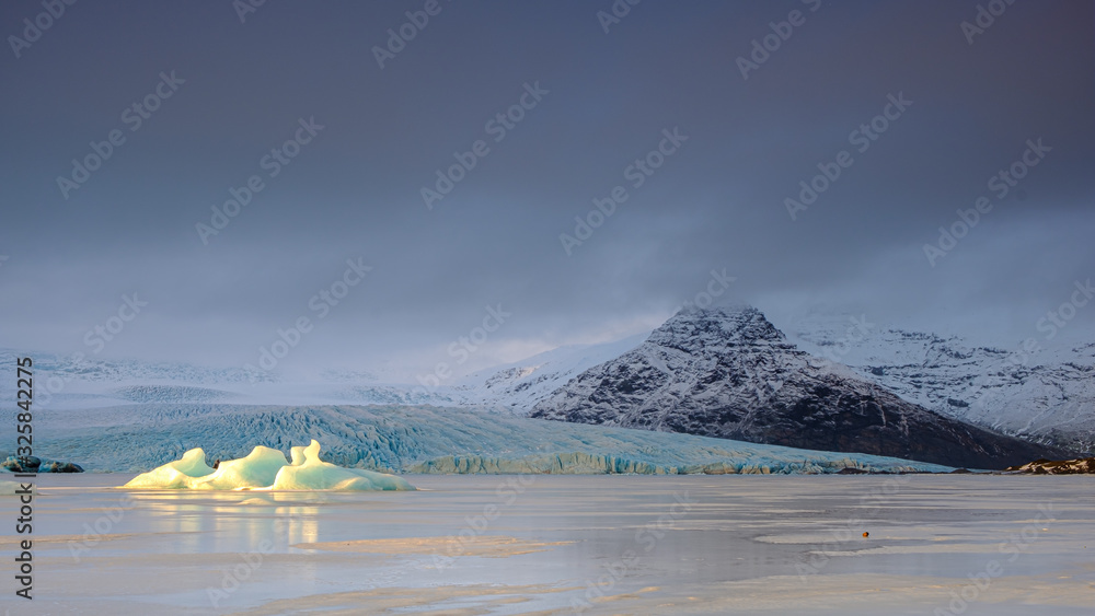 Iceland Svínafellsjökull Glacier: a combo of golden iceberg, dark mountain and blue glacier