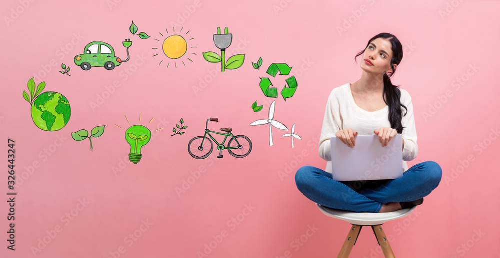 Eco theme with young woman using a laptop computer
