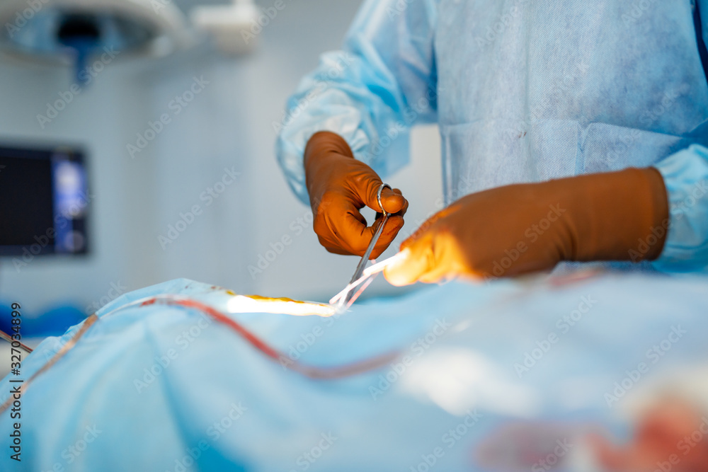 In surgery. Medical team performing operation in hospital operating theater. Working with surgical i