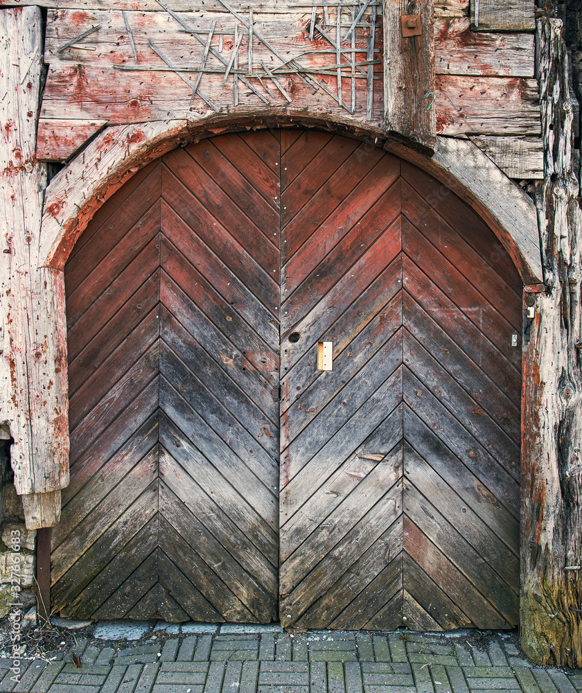 Wooden unpainted doors to backyard in Tallinn Old Town
