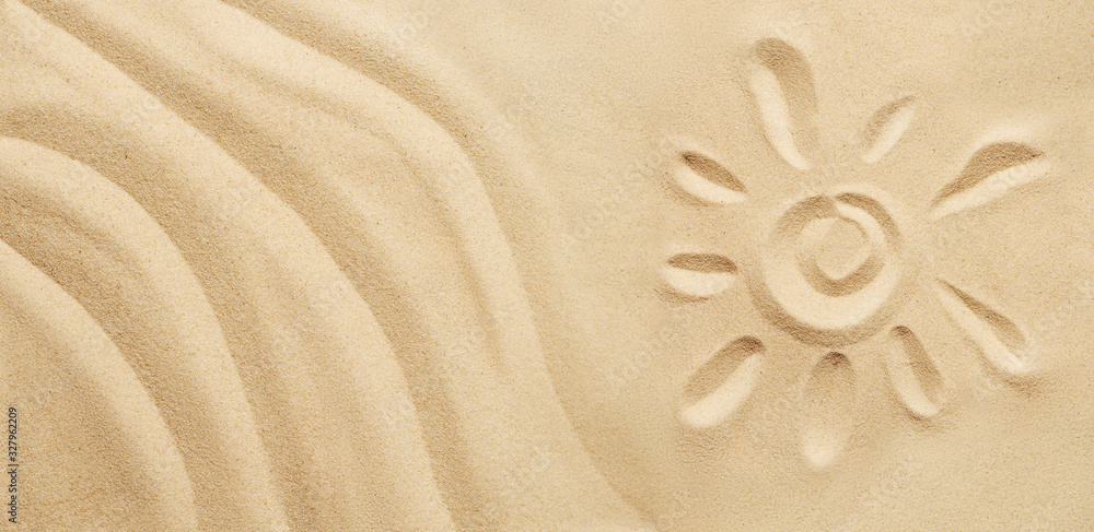 Tropical sand background with sand waves and sun. Sandy beach texture with copy space. Top view