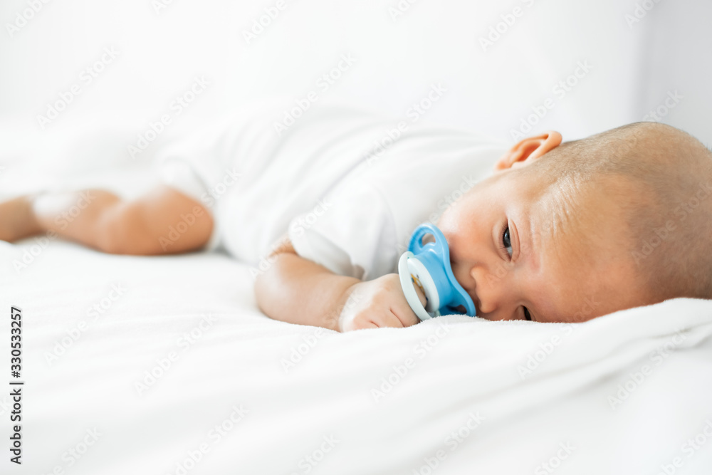 白色床上可爱的婴儿肖像，新生儿概念