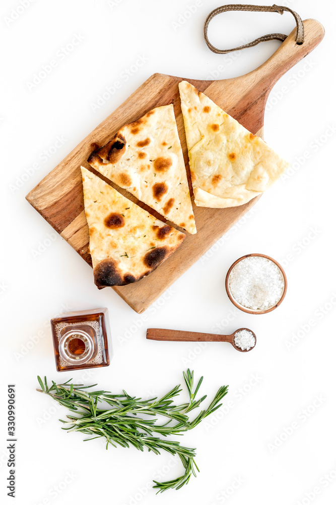 Italian focaccia with cheese and rosemary on white background top-down