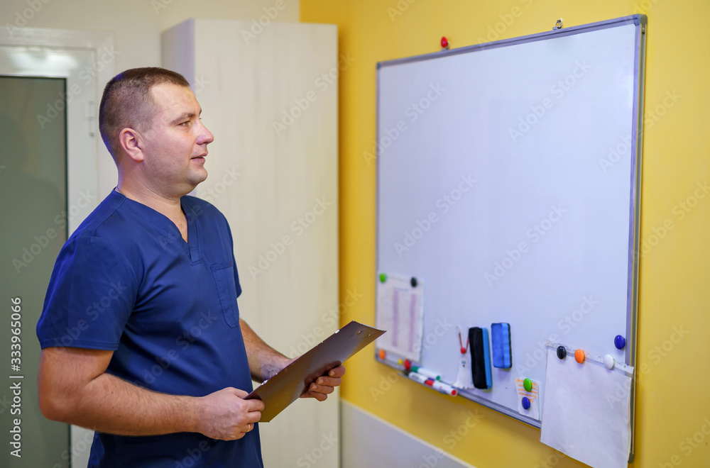 办公室里的医生站在黑板附近。白板上有笔记。专业专家的概念。Mee