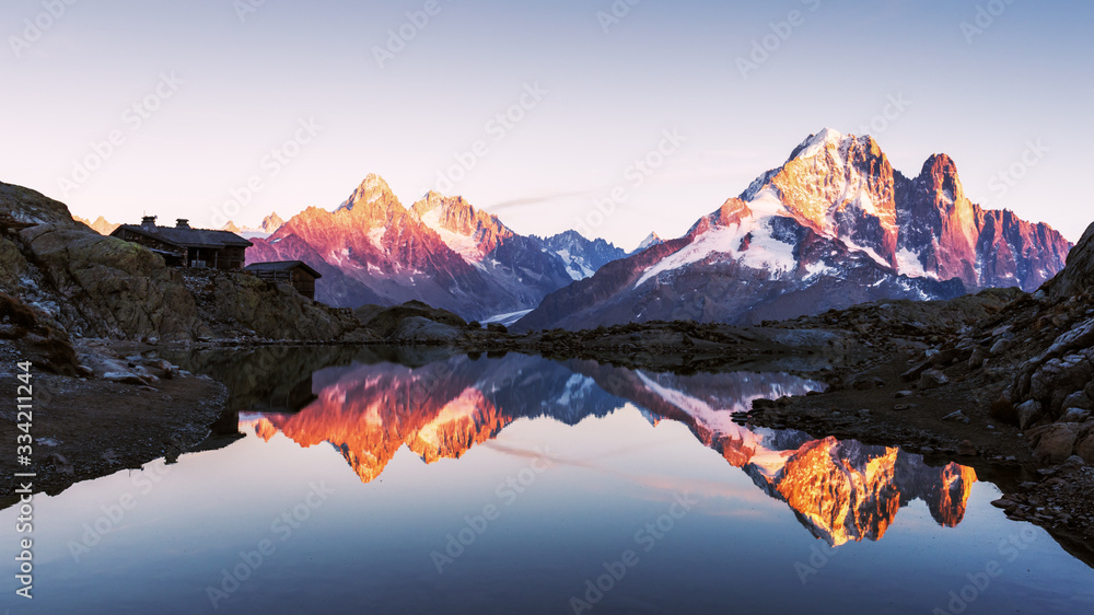 Colourful sunset on Lac Blanc lake in France Alps. Monte Bianco mountain range on background. Vallon