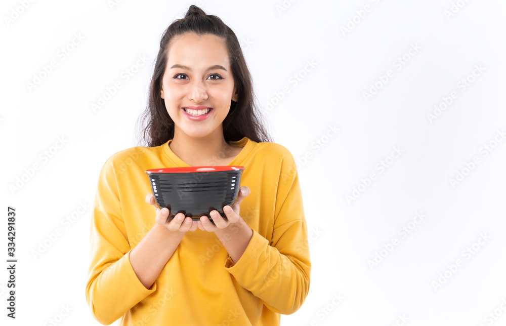 Young beauty Asian woman showing bowl prepare to eat food and she wearing a yellow sweater shot isol