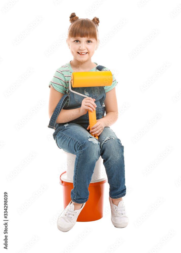 Little girl with paint roller on white background