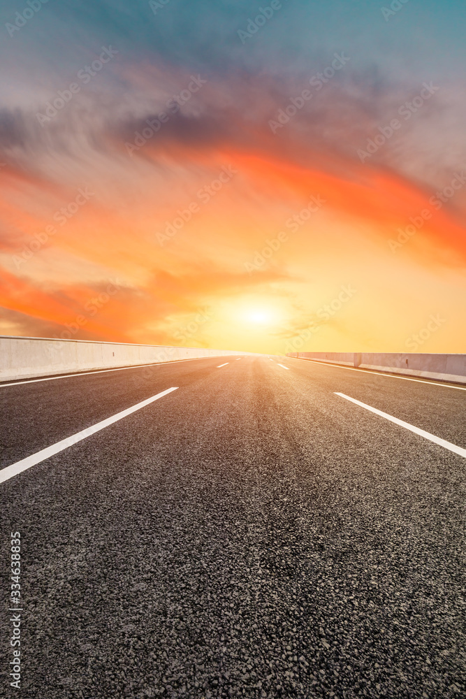 Asphalt highway road and sky sunset clouds landscape.
