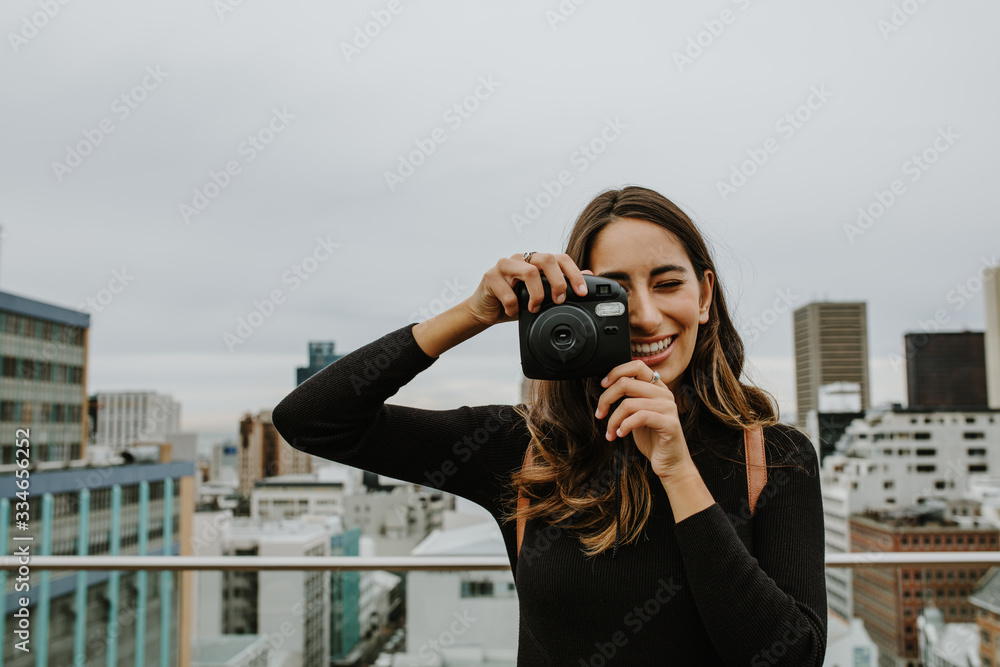 Woman taking pictures with an instant camera