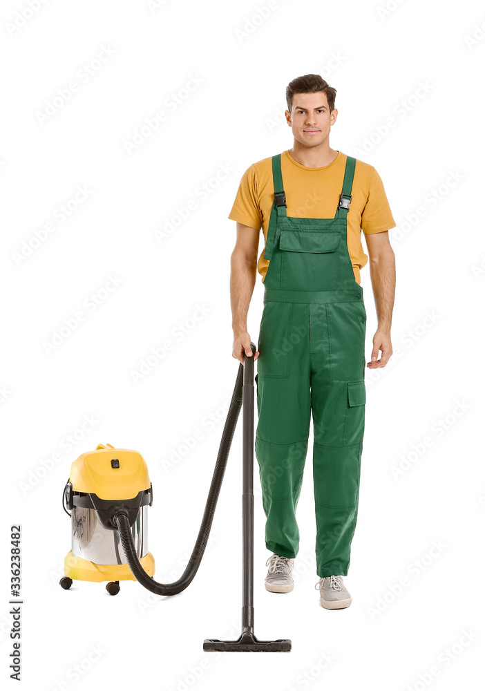 Young man with vacuum cleaner on white background