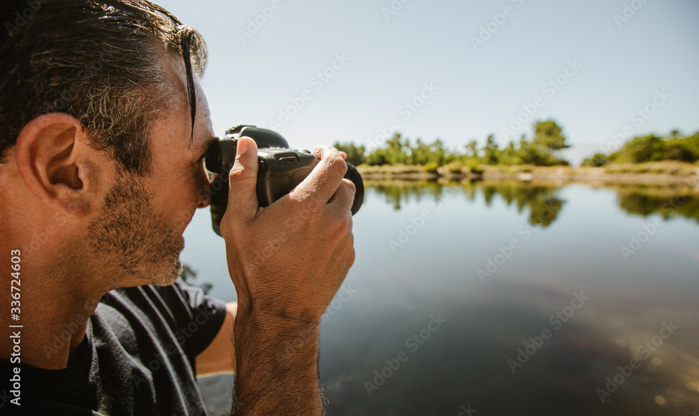 Wildlife photographer taking pictures of a lake