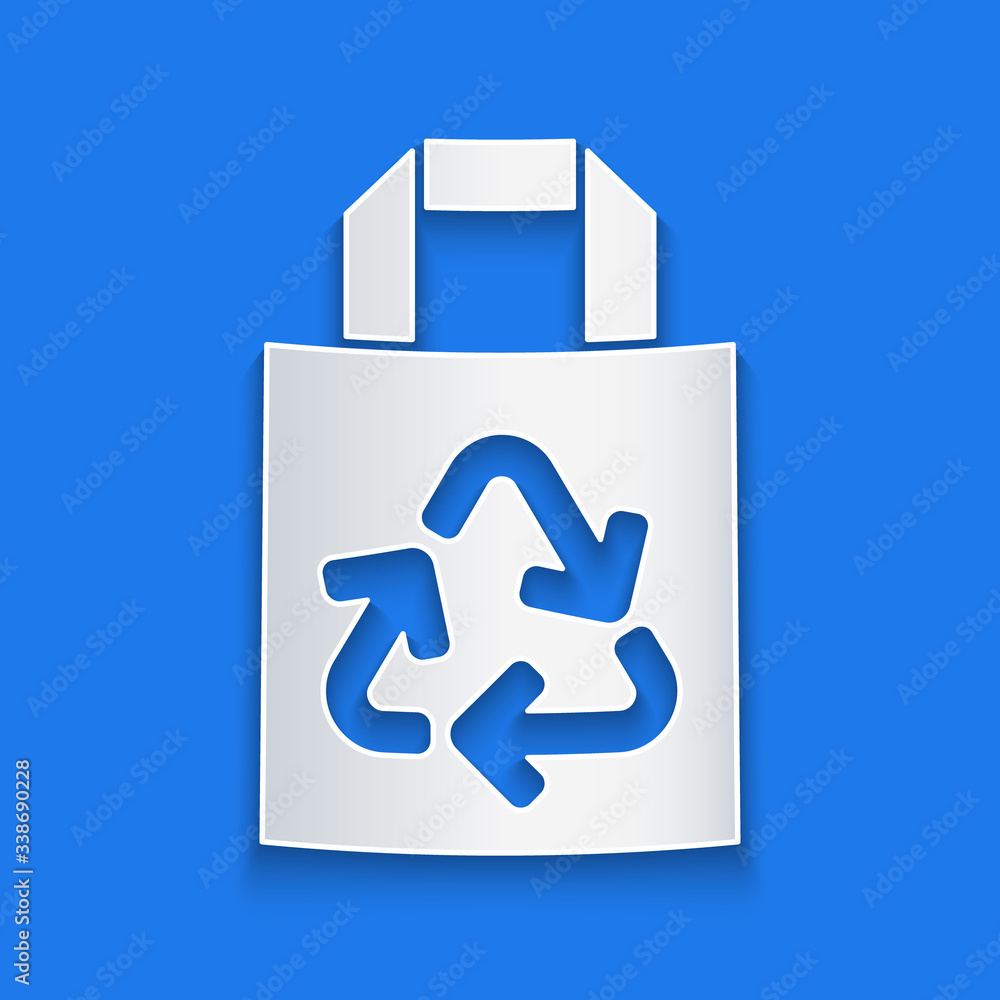 Paper cut Paper shopping bag with recycle icon isolated on blue background. Bag with recycling symbo