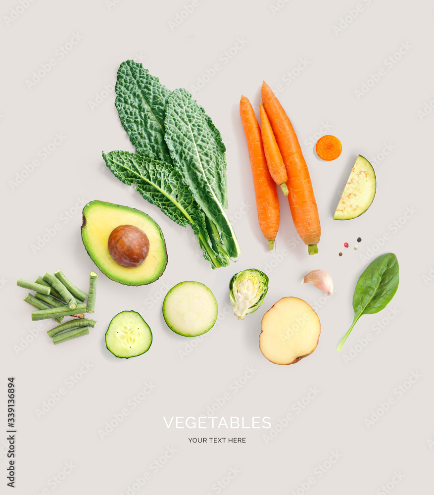 Creative layout made of avocado, carrot, kale, potato, cucumber, garlic and green beans. Flat lay. F