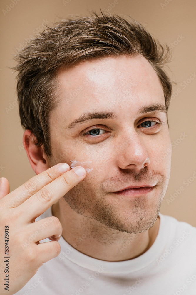 Man using facial cream