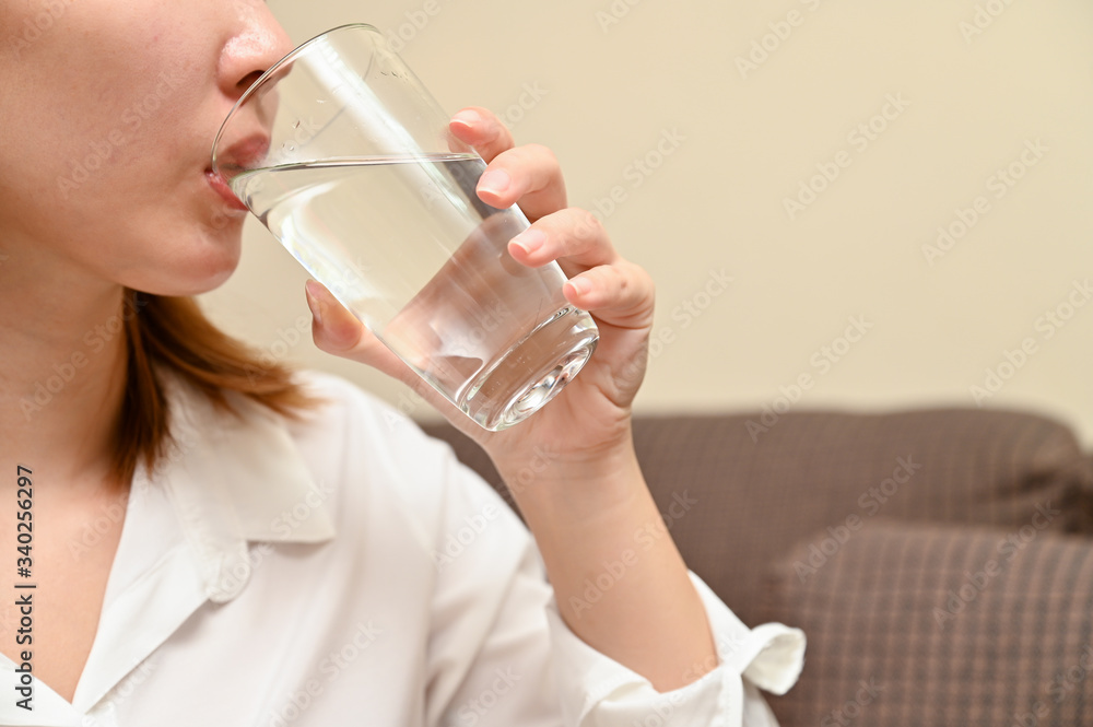 Close up young Asian woman drinking fresh water