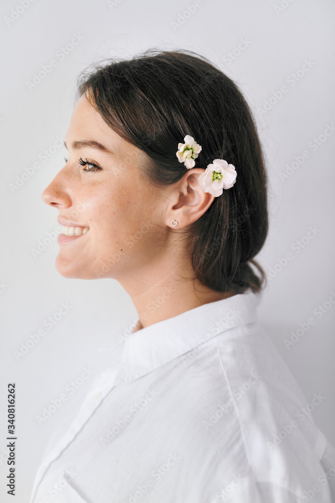 Portrait of a woman with floral earcuff