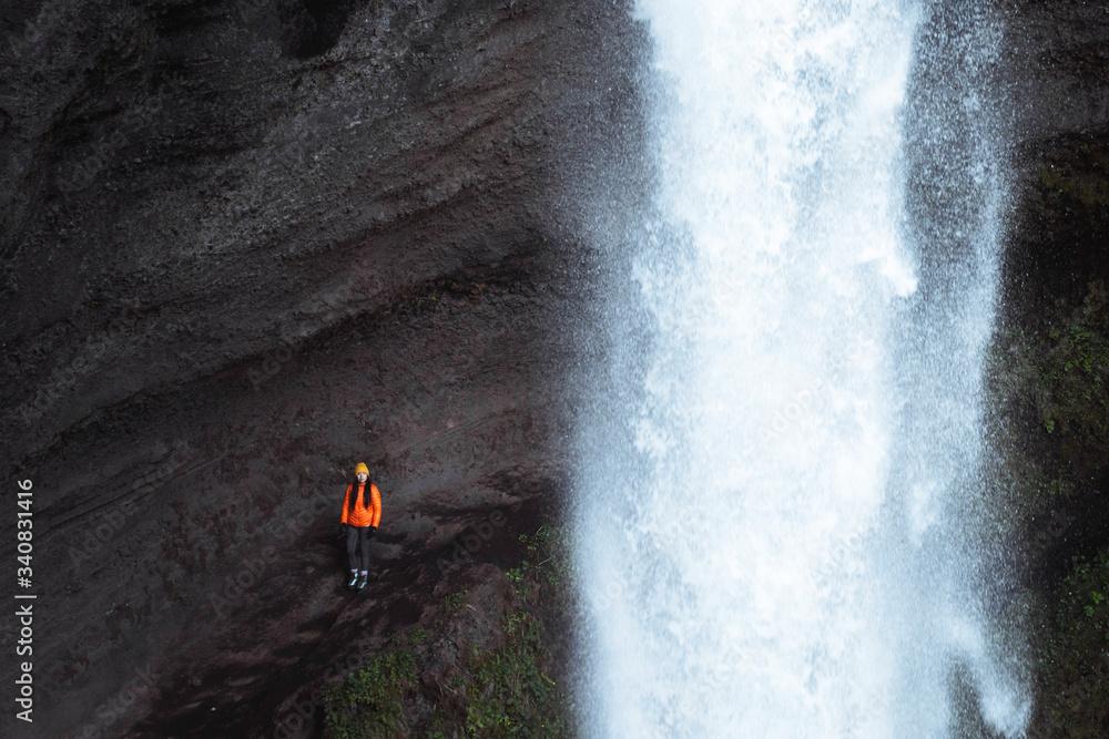 Traveler by a waterfall
