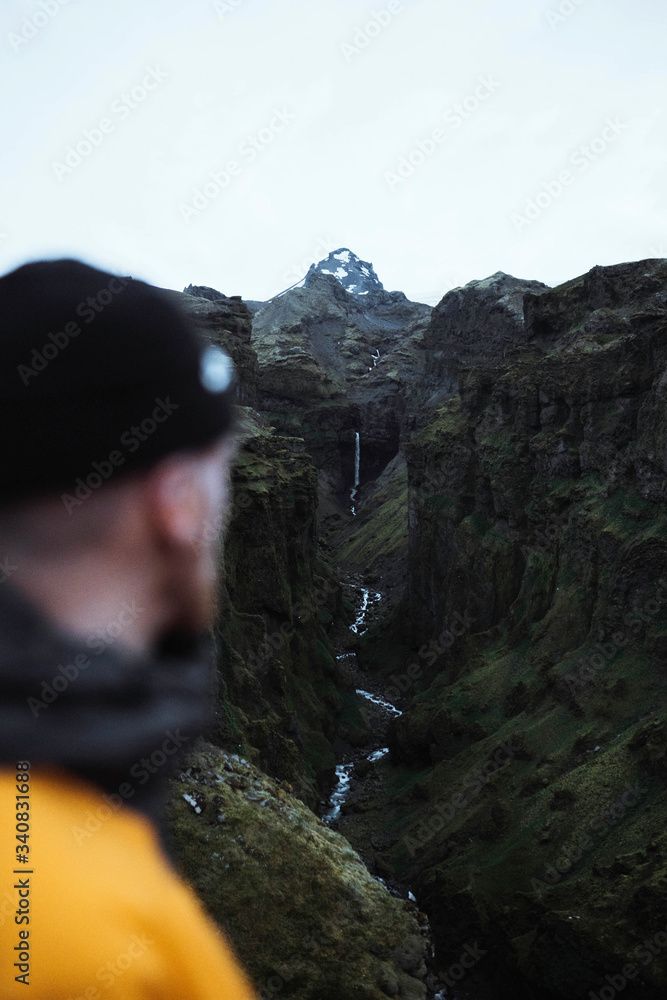 Traveler by a waterfall