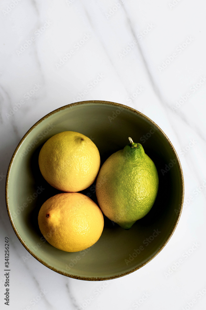 Yellow fresh organic lemons in a bowl