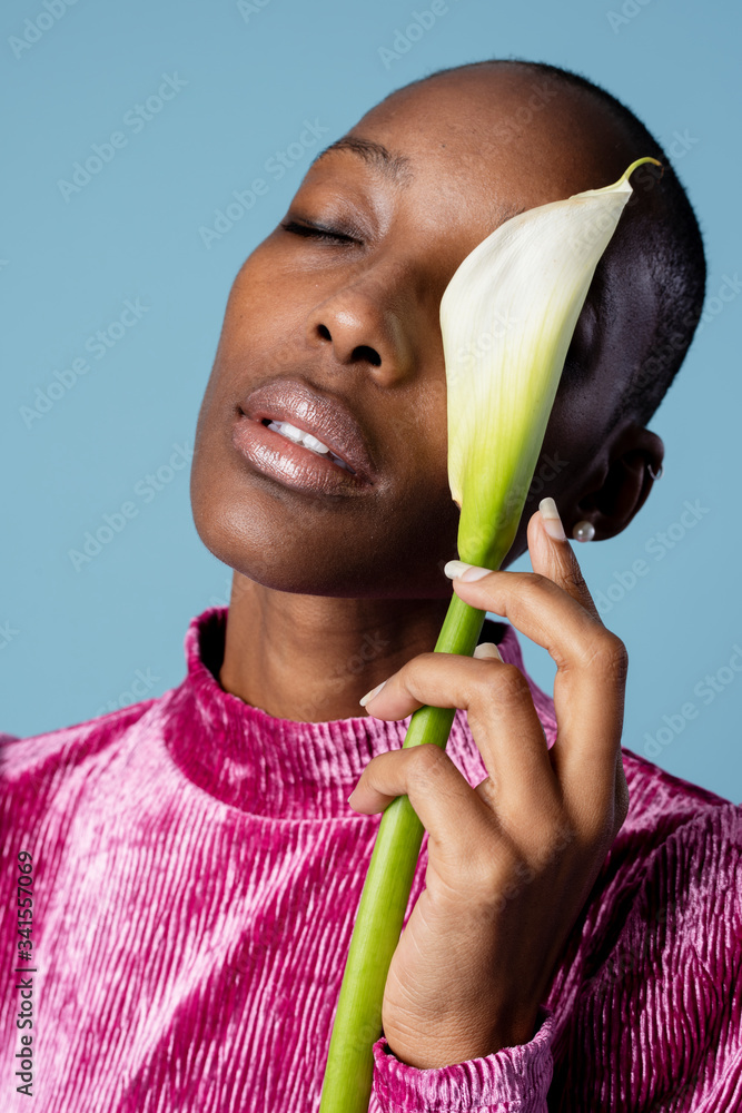 Portrait of a black woman with a white lily