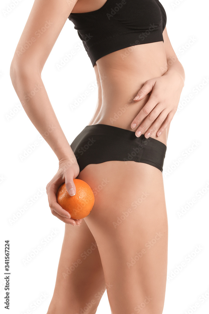 Young woman with orange fruit on white background. Concept of cellulite