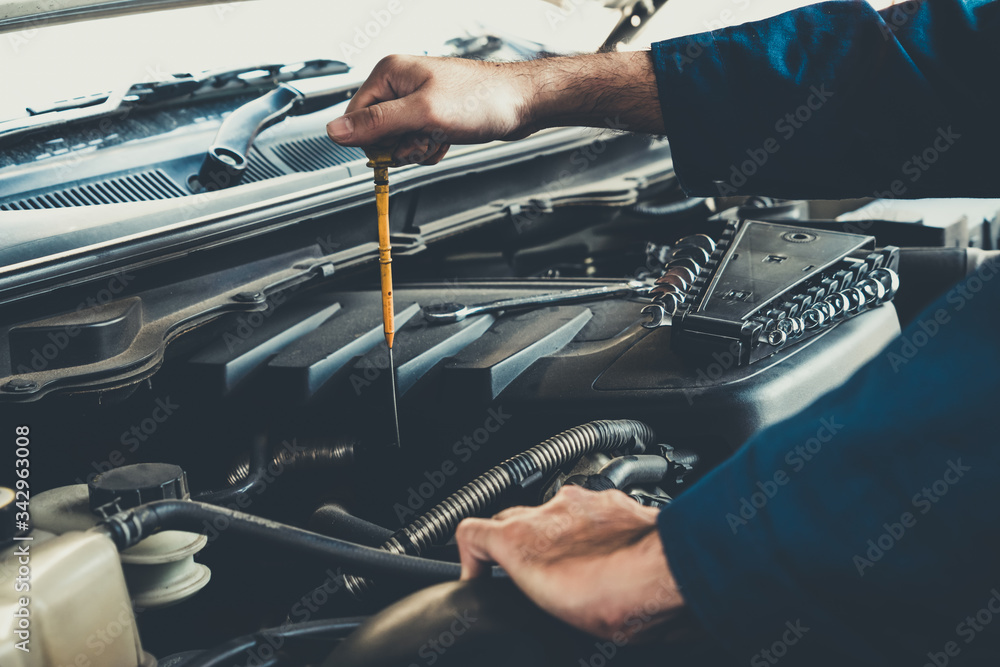 Professional mechanic providing car repair and maintenance service in auto garage. Car service busin