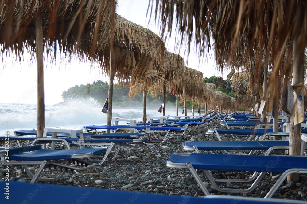 umbrellas on the beach in a stormy day - Therma, Samothraki, Greece