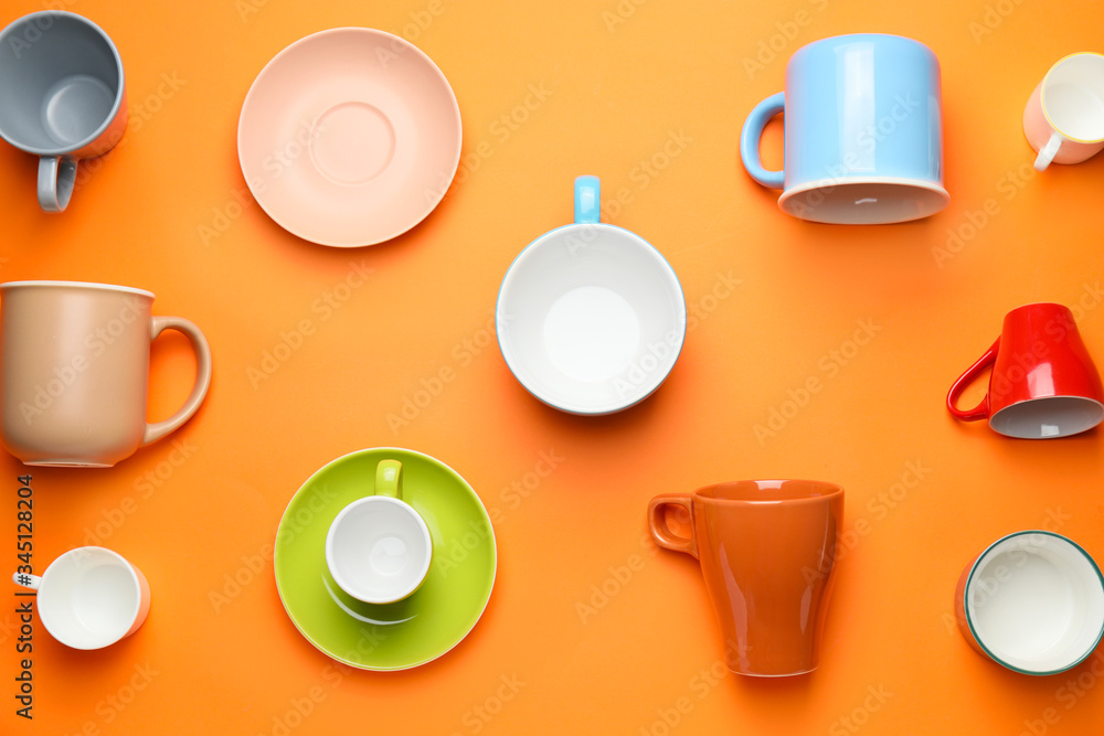 Many different cups on color background