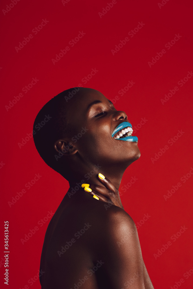 Smiling african woman with colorful makeup