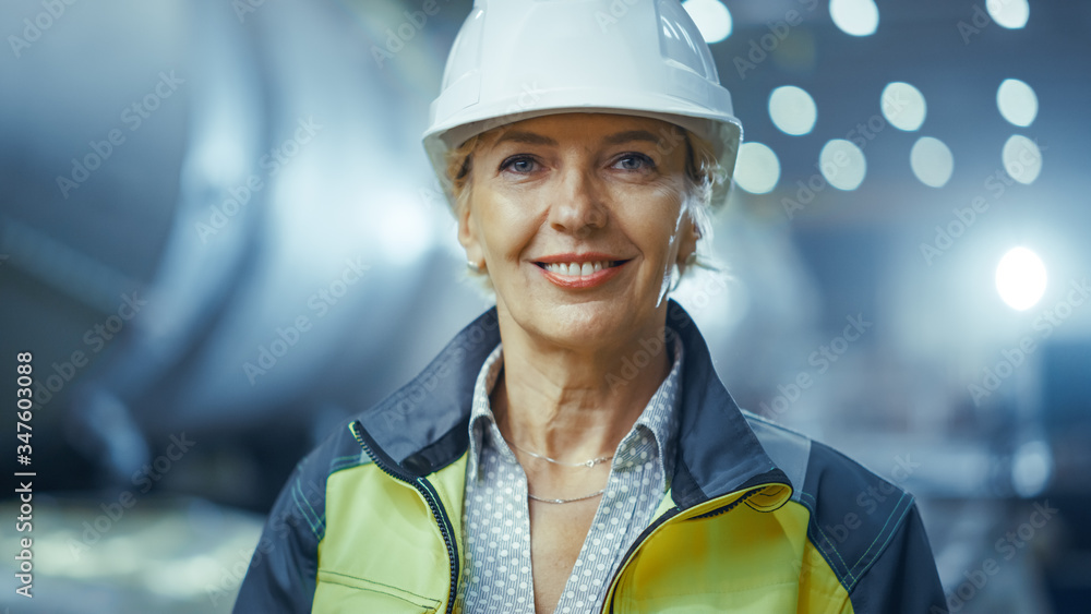 Portrait of Professional Heavy Industry Female Engineer Wearing Safety Uniform and Hard Hat, Smiling