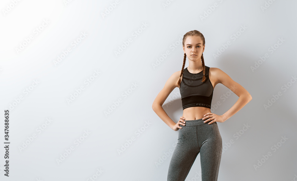 Woman in fashionable sportswear is doing exercise.
