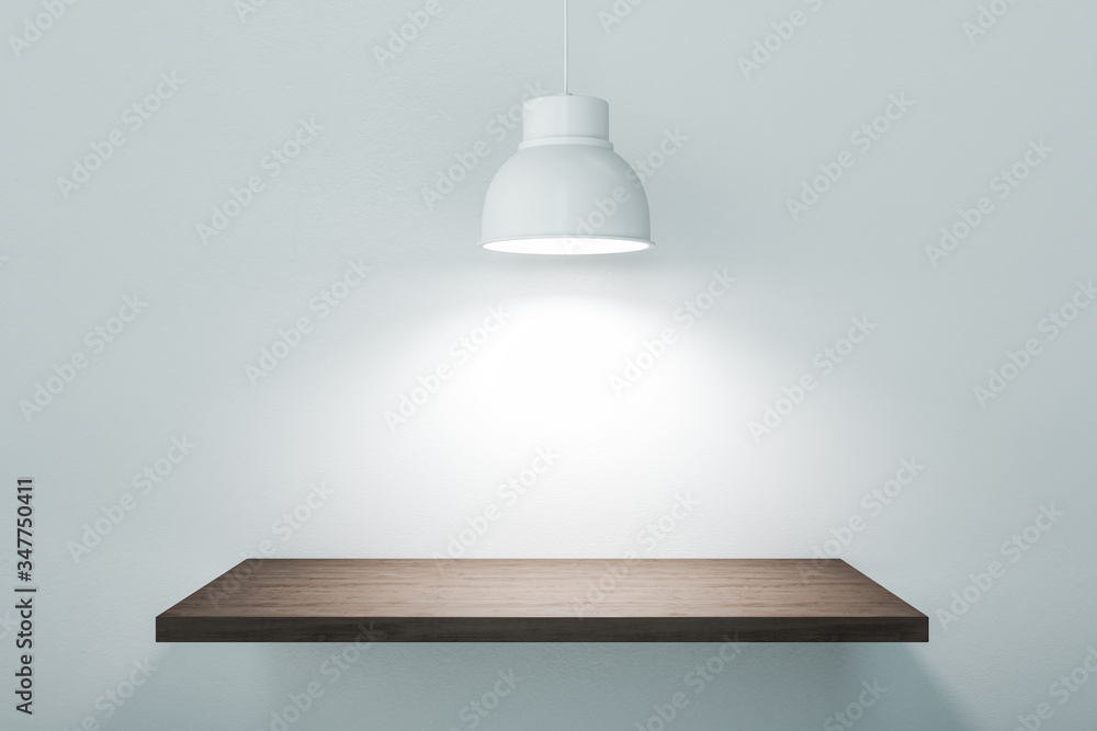 Wooden platform on concrete wall with spotlights.