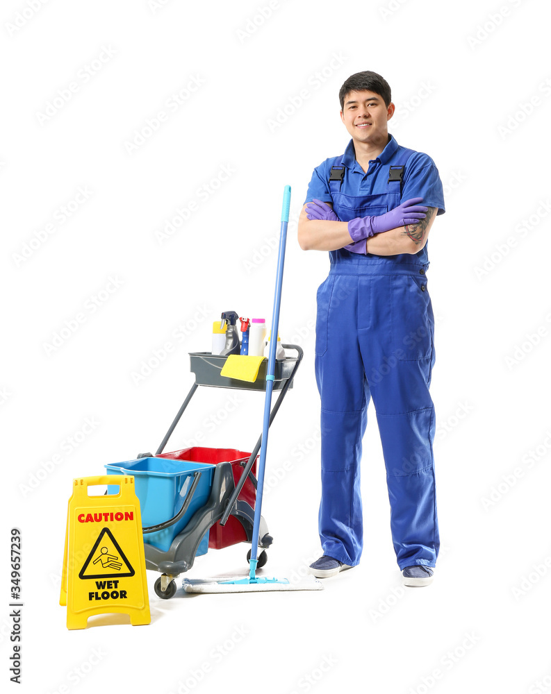 Male janitor with cleaning supplies on white background