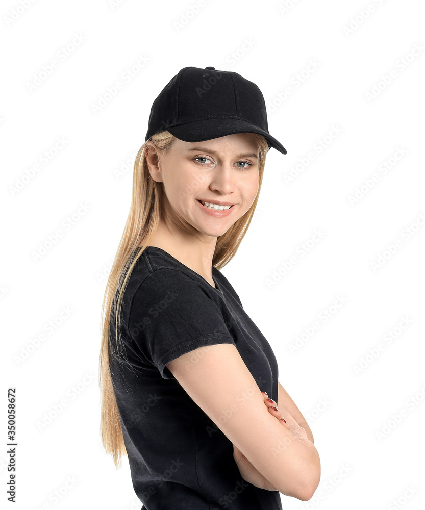 Beautiful young woman in stylish cap on white background
