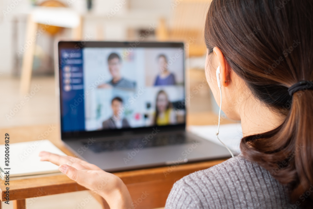 Young Asian businesswoman work at home and virtual video conference meeting with colleagues business
