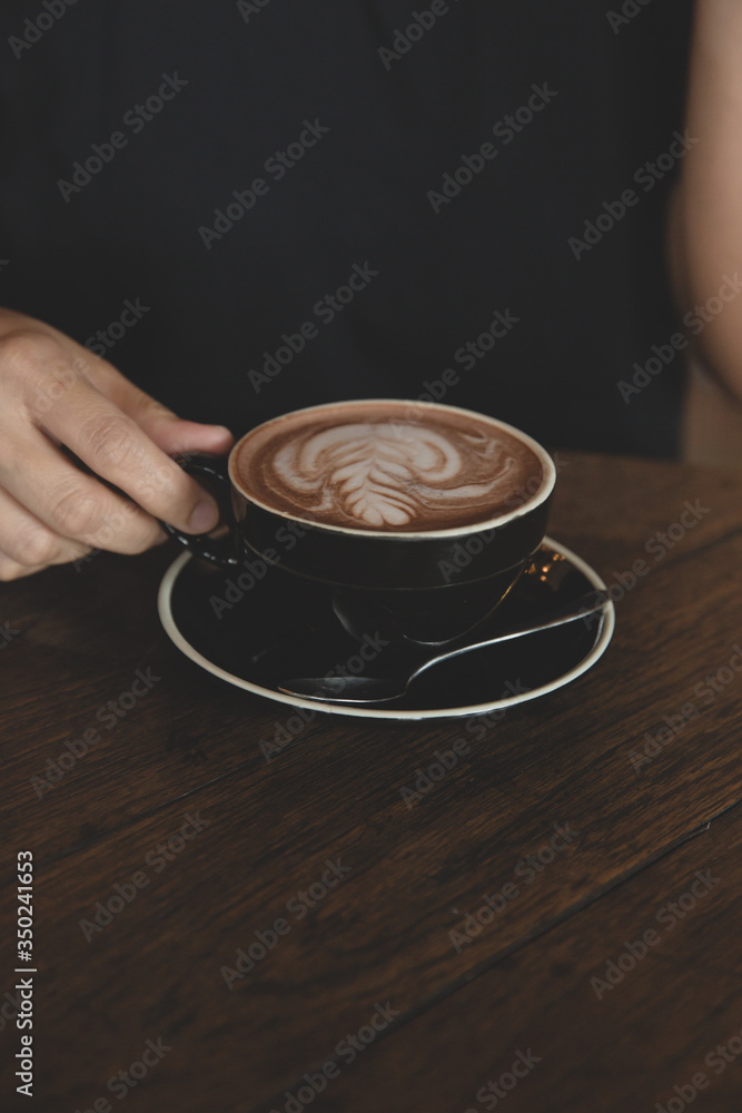 Closeup of hands with coffee cups in a cafe