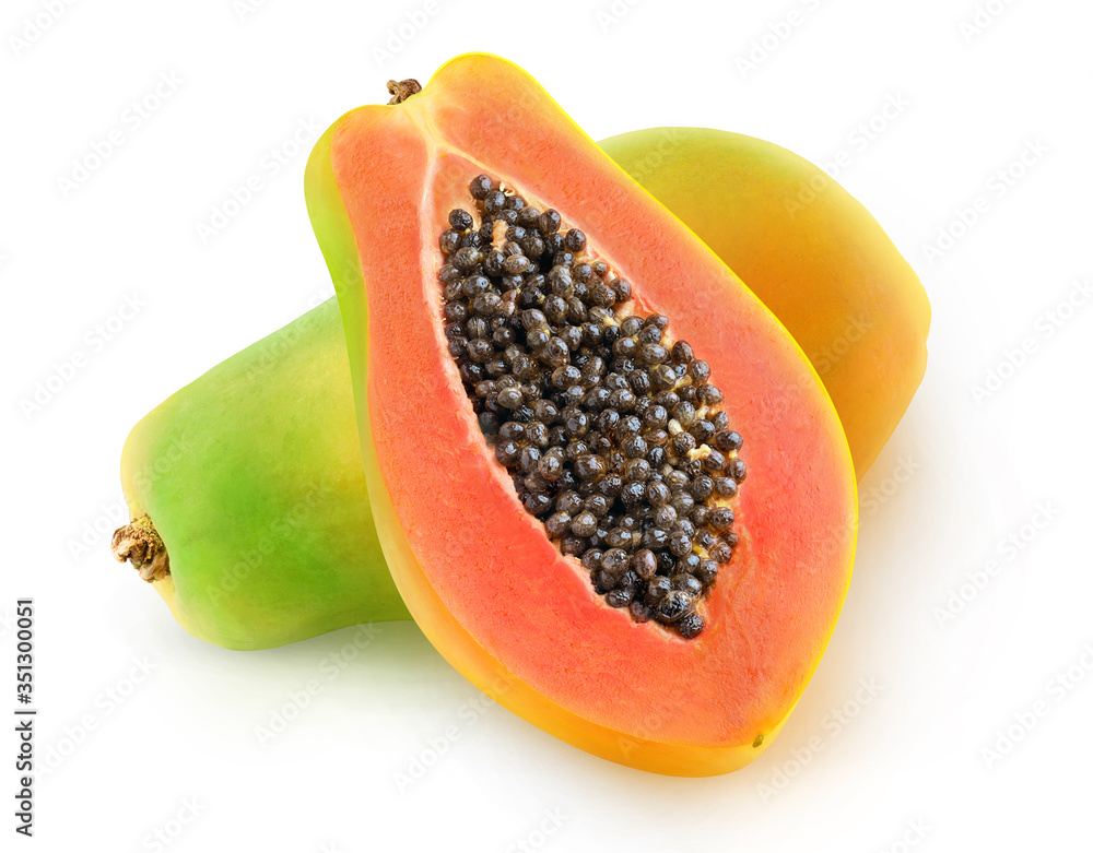 One whole multicolored papaya fruit and a half with seeds isolated over white background