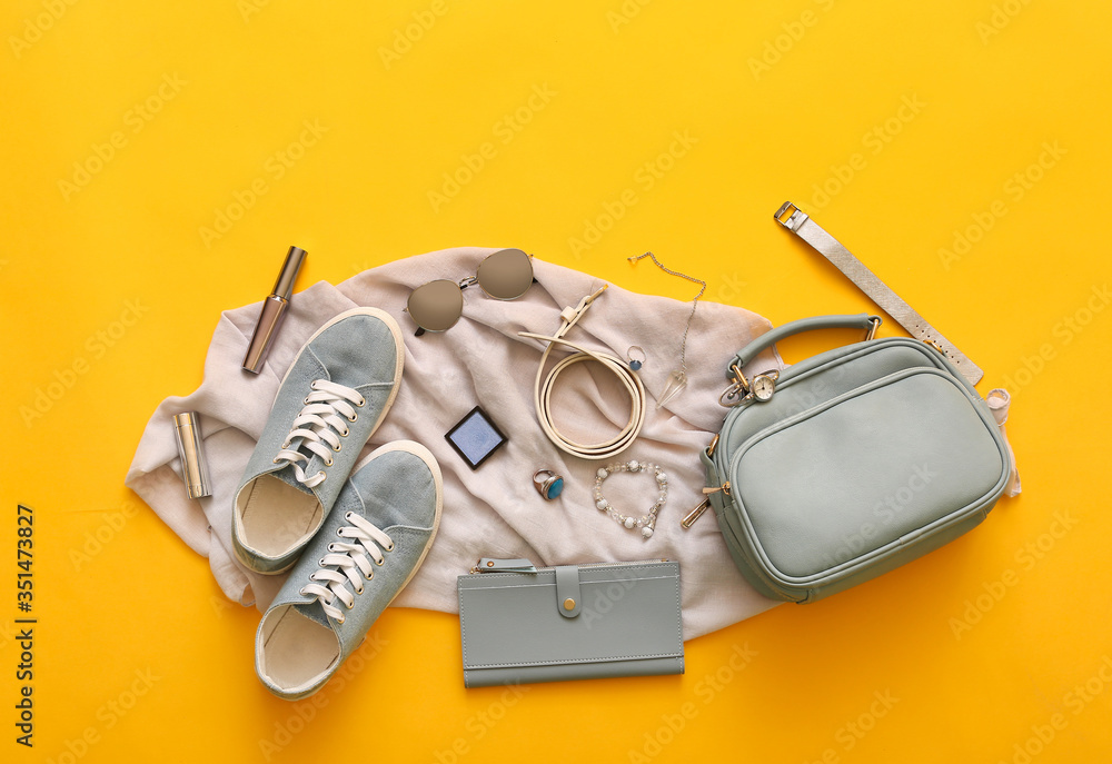 Female accessories on color background