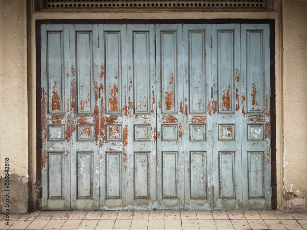 The old blue wooden door in the old building, isolated.