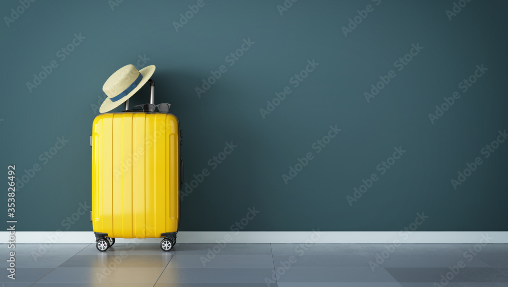 橙色手提箱，带草帽和太阳镜，靠墙立着。空荡荡的spac旅行概念