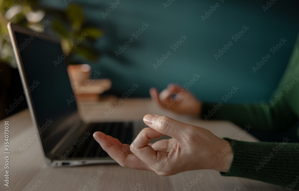 Work Life Balance Concept. Woman sitting on Desk and making the Meditation while Working on Computer