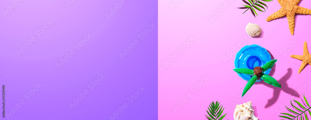 Summer concept with a palm tree float overhead view - flat lay