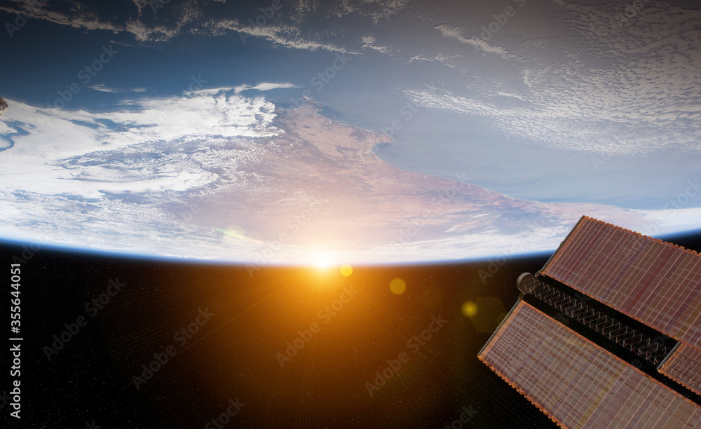 日出期间从空间站窗口观看地球的景象，该图像的3D渲染元素