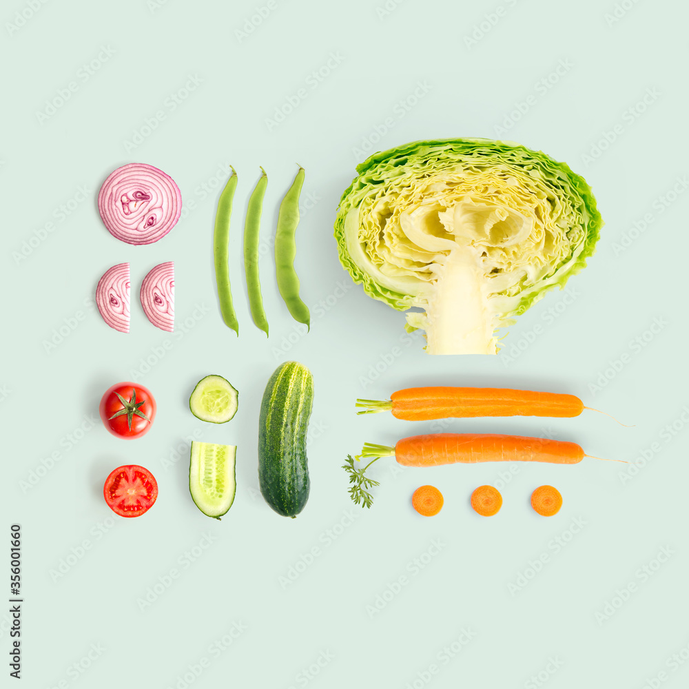 Creative layout made of cucumber, carrot, tomato, onion and cabbage and green beens. Flat lay. Food 